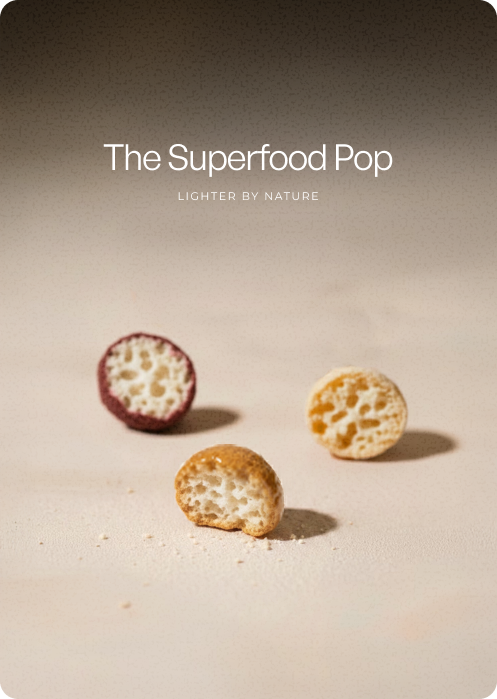 Three halved air-popped lotus seed snacks in different coatings — red, golden, and plain — arranged on a light surface, each cross-section showing a consistent porous, airy interior. 